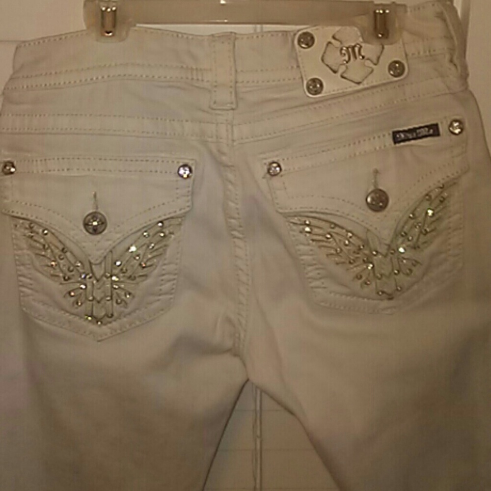 A pair of white Miss Me jeans